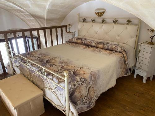 a bedroom with a bed with a white comforter at Casa Muscettola in Leporano