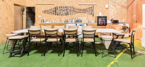 a dining room with a table and chairs and a kitchen at Malvern Hills View Glamping 16+ in Bosbury