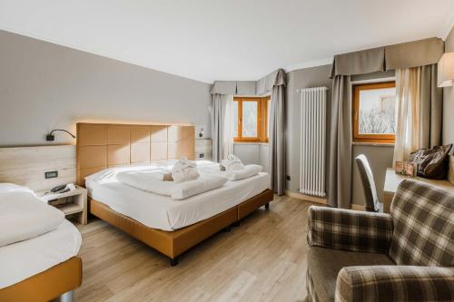 Letto o letti in una camera di Family Hotel Gran Baita