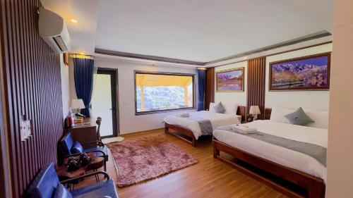 a hotel room with two beds and a window at Sapa Eco Villas & Spa in Sa Pa