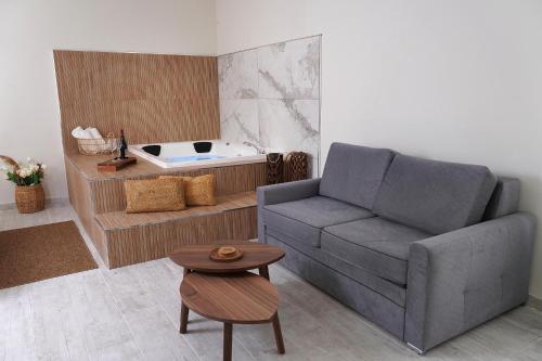 a living room with a couch and a bath tub at הקצה- The Edge in Sifsufa