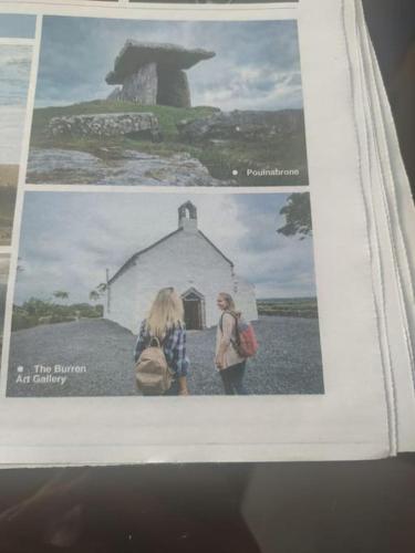 a picture of two women standing in front of a building at The Burren Art Gallery built in 1798 in Tubber