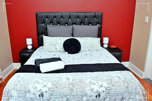 a bedroom with a large bed with a red wall at THE GLOBAL LINK HUB in Pretoria