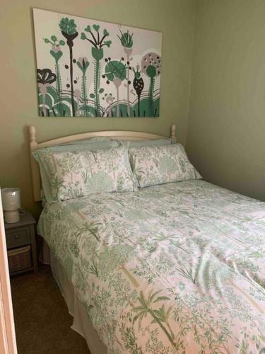 a bedroom with a bed with a floral bedspread at The Court in Belfast