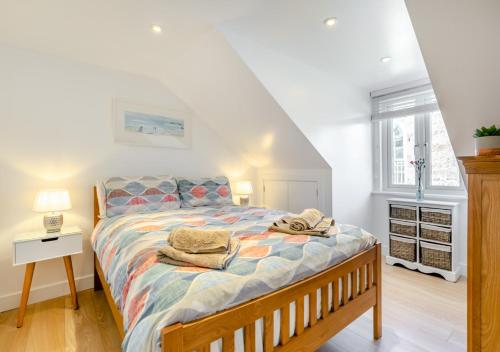 a bedroom with a bed with towels on it at Hendys Loft in St Ives