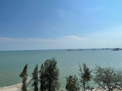 a view of a large body of water with trees at Mutiara Melaka Beach Resort by Minso in Tangga Batu