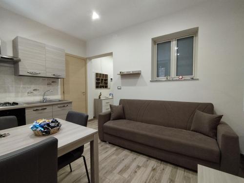 a living room with a couch and a table at Casa Paolina in Militello in Val di Catania