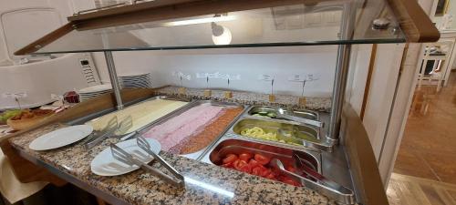a kitchen with a sink with food in it at Batthyány Kastélyszálló in Zalacsány