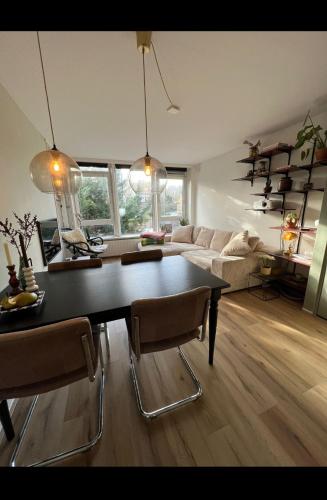 a living room with a table and a couch at Apartment Mellow Stay Amsterdam in Amsterdam