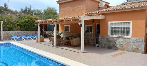 a house with a swimming pool in front of a house at Villa Casa Kenaz in El Campello