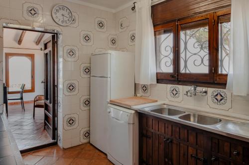 a kitchen with a sink and a refrigerator at Villa Ventisca in Platja  d'Aro