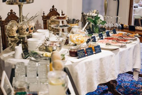 a table with dishes of food on it at Amplatz 1523 - B&B and Suites in Montagna