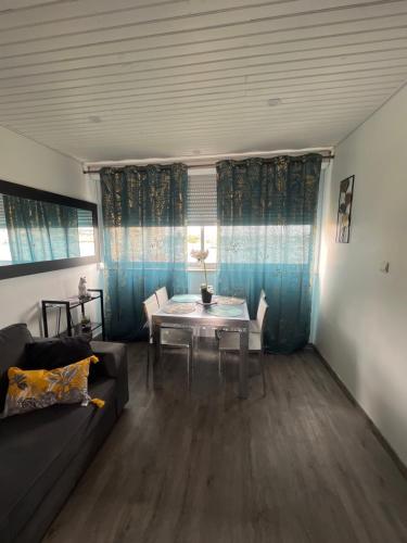 a living room with a table and a couch at 46 Île Paradise Vue Port in Cap d'Agde