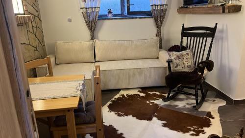 a living room with a couch and a chair at Vila LEMAR wellness & spa in Huncovce