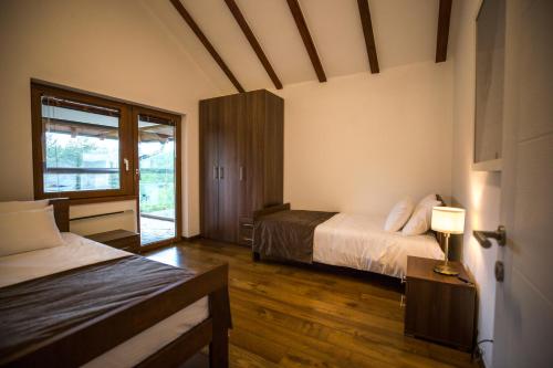 a hotel room with two beds and a window at Divna Vila in Vrnjačka Banja