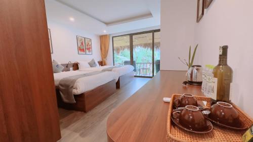 a hotel room with two beds and a table with a table sidx sidx at Sapa Eco Villas & Spa in Sa Pa