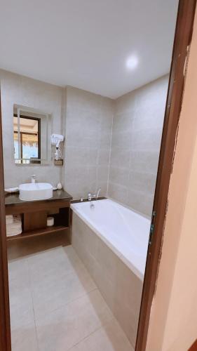 a bathroom with a bath tub and a sink at Sapa Eco Villas & Spa in Sa Pa