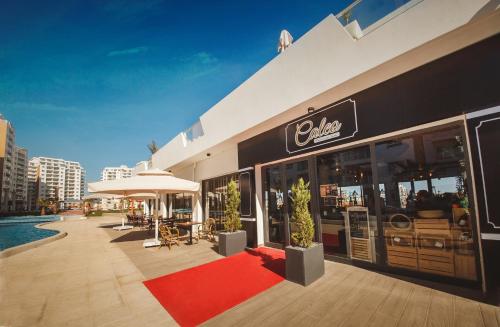 a restaurant with a red carpet in front of a building at Spacious One Bedroom Apartment in Caesar Resort & SPA, Long Beach in Perivolia tou Trikomou