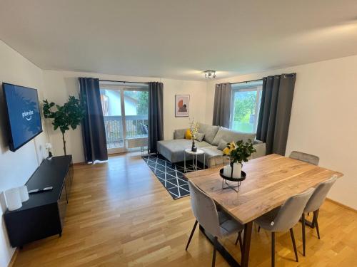 a living room with a table and a couch at homy Bludenz Alpine Panorama in Bludenz