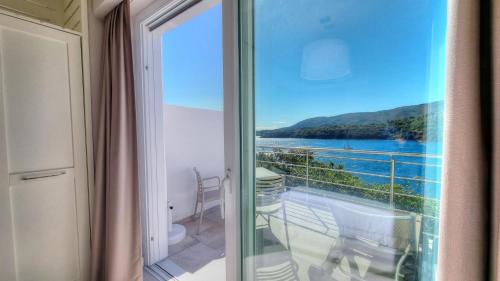 a balcony with a view of the water at Hotel Plaza in Porto Azzurro