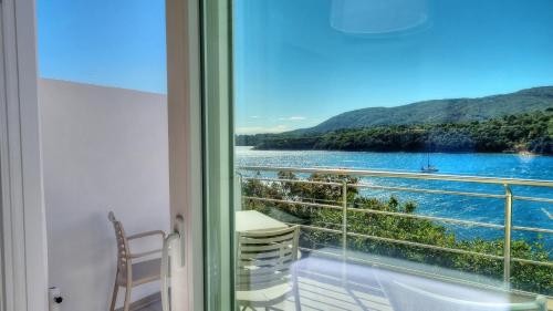 a room with a window with a view of the water at Hotel Plaza in Porto Azzurro