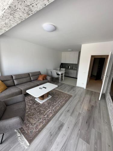 a living room with a couch and a table at ShooTer Apartments in Ferizaj