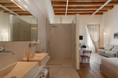 a bathroom with two sinks and a living room at Massimago Wine Suites in Verona