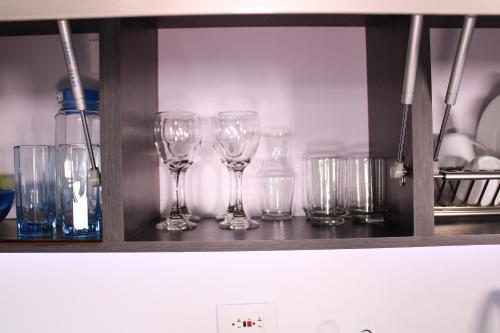 a row of wine glasses sitting on a shelf at Mio Loft - Vista El Poblado Free Parking Recepción 24h High Internet in Medellín