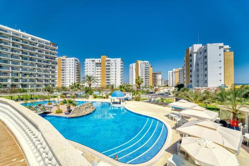 a resort with a swimming pool and some buildings at Spacious One Bedroom Apartment in Caesar Resort & SPA, Long Beach in Perivolia tou Trikomou