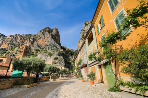 a street in positano with a mountain in the background at La maison des collines in Allemagne-en-Provence