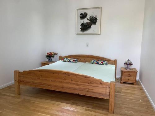 a bedroom with a wooden bed in a room at Castle and Park View Living in Weilburg in Weilburg