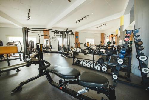 a gym with several tread machines in a room at Spacious One Bedroom Apartment in Caesar Resort & SPA, Long Beach in Perivolia tou Trikomou