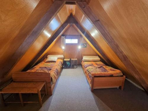 a room with three beds in a attic at Chalet Saint-Michel-de-Chaillol, 3 pièces, 5 personnes - FR-1-393-13 in Saint-Michel-de-Chaillol