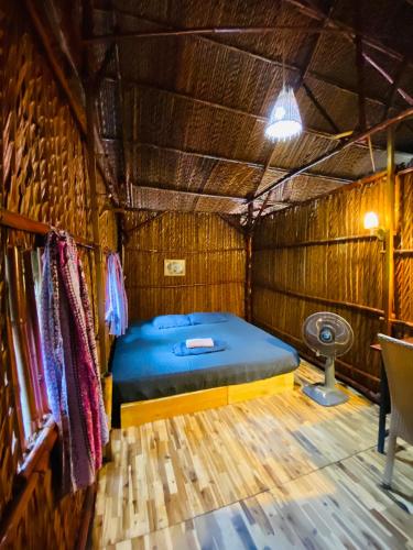 a bedroom with a bed in a straw hut at Saigon Garden Homestay in Ho Chi Minh City