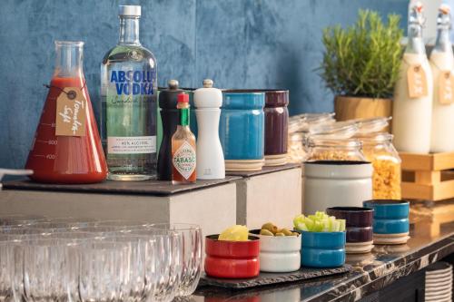 a counter with many bottles and containers of food at Strandhotel Ahlbeck in Ahlbeck