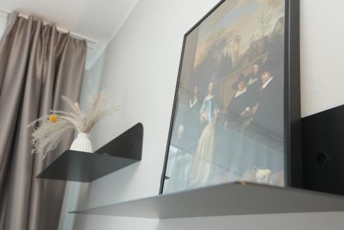 a picture of a wedding picture on a wall at Boutique Kaiser - Hotel & Apartments in Frankfurt/Main