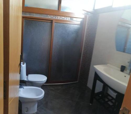 a bathroom with a shower and a toilet and a sink at House near beach in M'diq