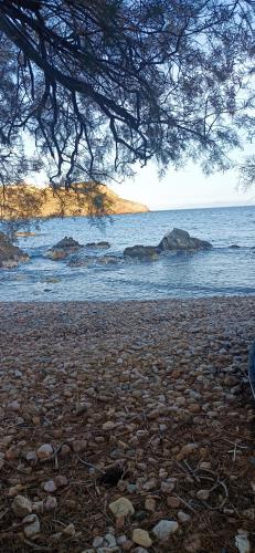 a view of a beach with rocks in the water at Peristeronas in Liaropá