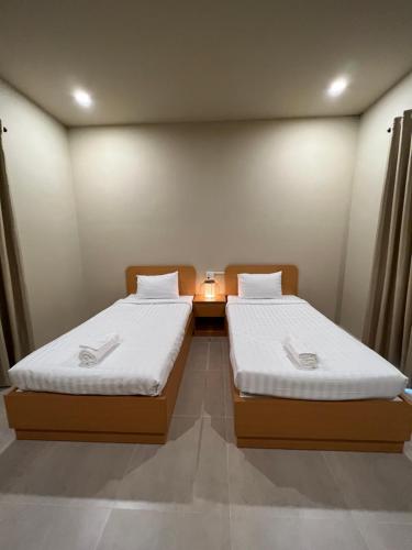 two beds in a small room with at escVACA - Your Stay in Mui Ne in Mui Ne
