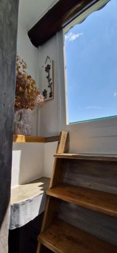 a set of stairs in a room with a window at Maison PORTIRAGNES près de la mer et du Canal du Midi in Portiragnes