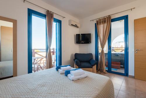 a bedroom with a bed with towels on it at Blue Sea Villa in Gennadi