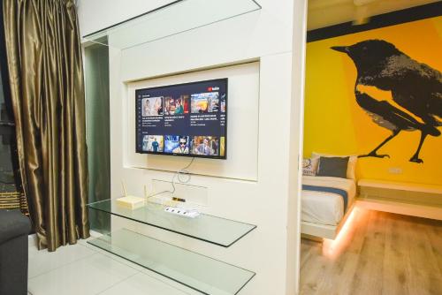 a room with a tv and a bird on the wall at Midvalley Southkey Mosaic Suite by Nest Home in Johor Bahru