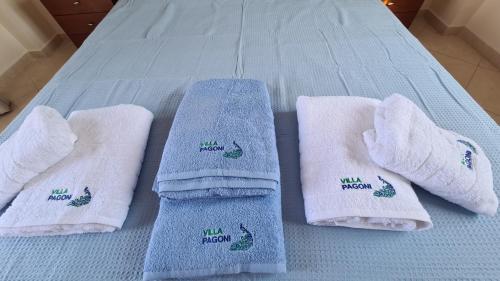 a group of white socks on a bed at VILLA PAGONI Residence Selini Villas N 1 Kolymbari Chania in Kolymvari
