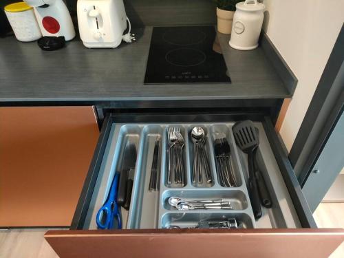 a drawer in a kitchen with utensils in it at Edge Luxury Ocean view Pattaya in Pattaya