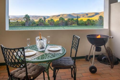 a table and chairs in a room with a view at Montagu Little Sanctuary - Hot Spring Access at Special Rate in Montagu