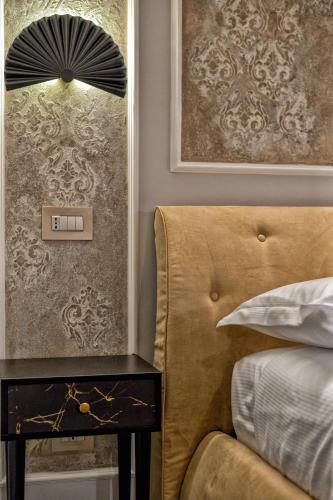 a bedroom with a bed and a side table with a lamp at Ancona e Riviera Luxury b&b in Ancona