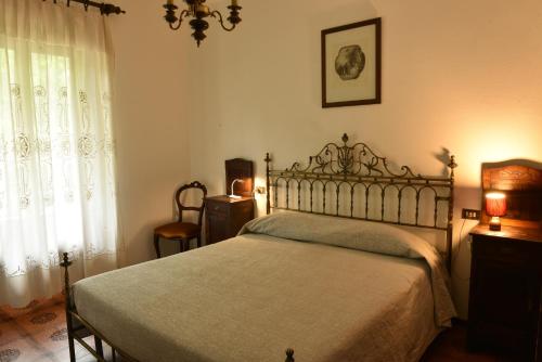 a bedroom with a bed and a window at Hotel Madonna di Luciago in Armeno