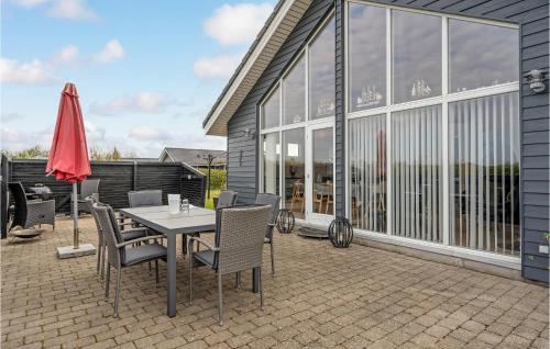 a patio with a table and chairs and a umbrella at Gorgeous Home In Tarm With Wifi in Tarm