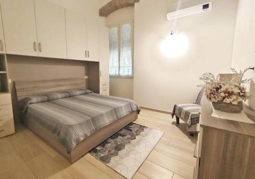 a bedroom with a bed and a couch in it at Le Maree Enea in Portoferraio