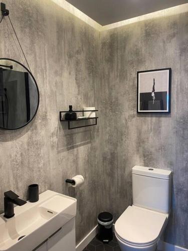 a bathroom with a white toilet and a sink at 55 High Street in Hastings